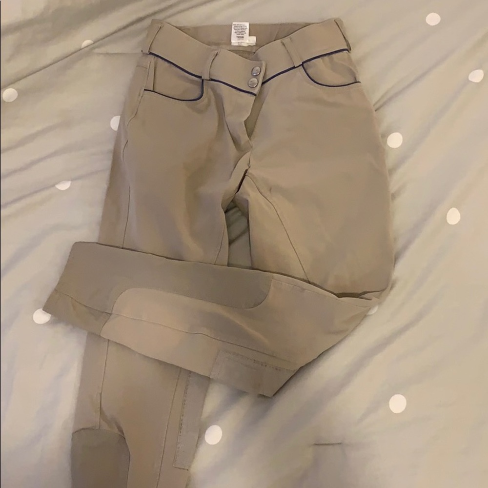 Tan riding breeches with blue pipping accent